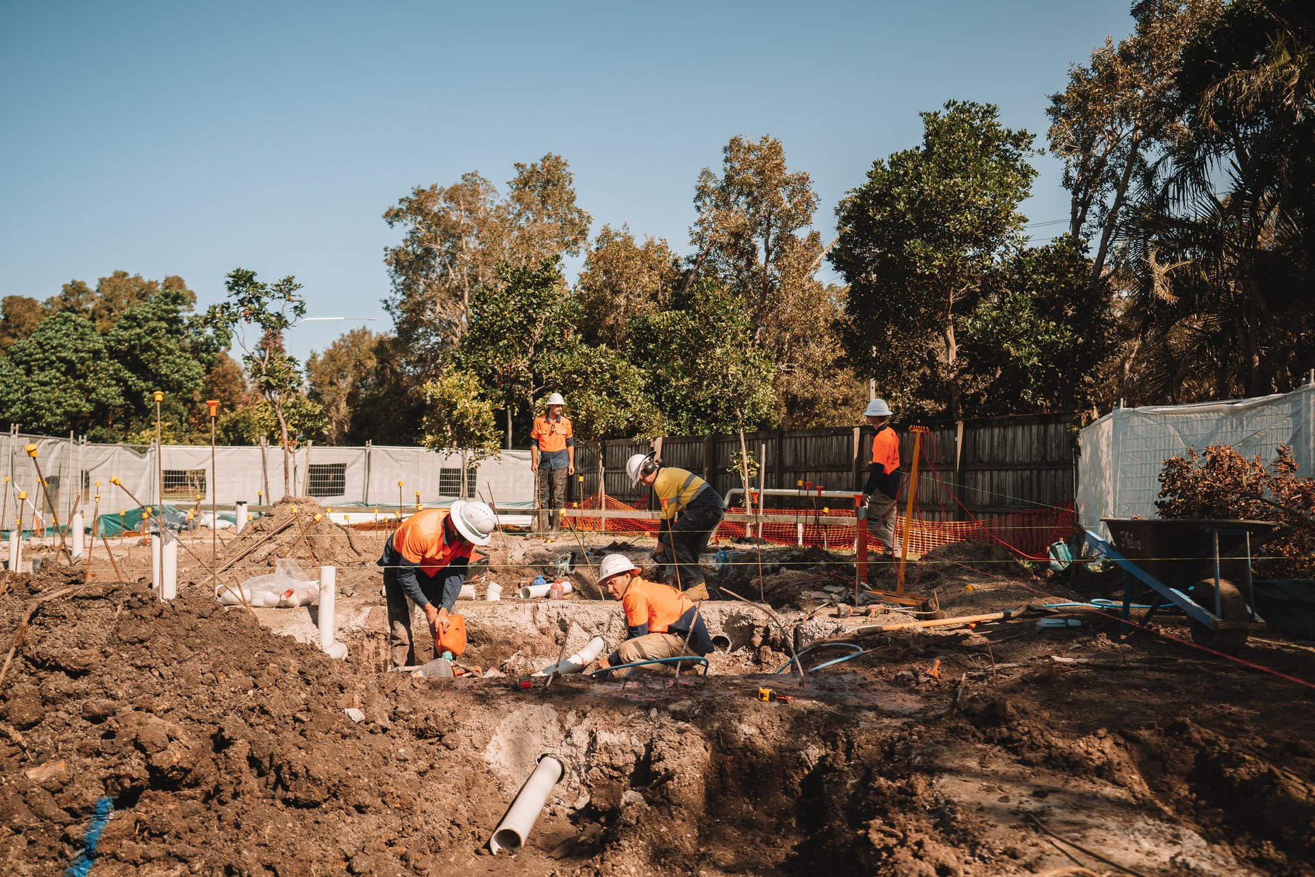Laying stormwater and sewer lines in trench