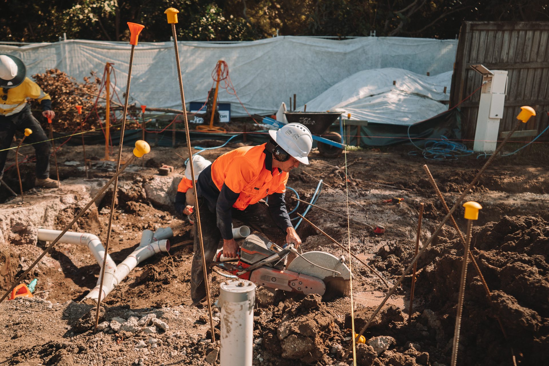 Plumber connecting pipework on site